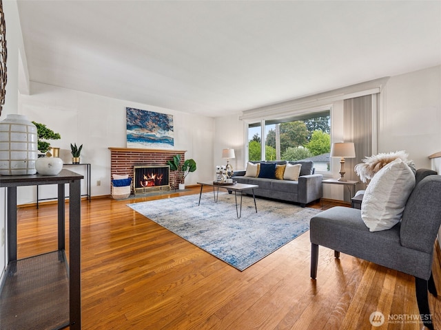 living room with a fireplace and wood finished floors