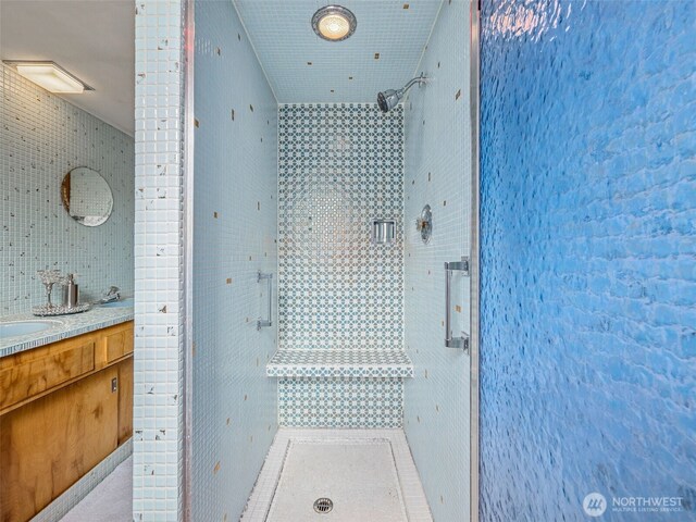 full bath with vanity and a shower stall