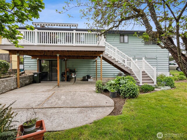 back of property featuring stairs, a patio area, a wooden deck, and a lawn