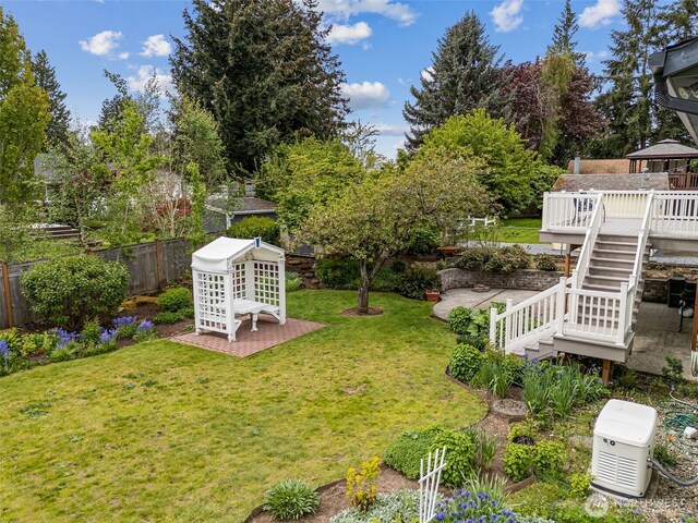 view of yard featuring fence, stairs, a gazebo, and a deck