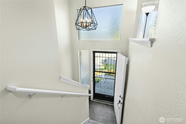 2524 171st St SE, Bothell, WA 98012 - foyer with plenty of natural light, dark tile patterned floors, a chandelier, and a textured wall