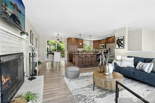 2524 171st St SE, Bothell, WA 98012 - living room with light wood-style flooring, a fireplace, and recessed lighting
