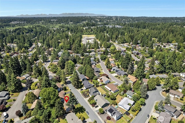2524 171st St SE, Bothell, WA 98012 - aerial view of property's location featuring a heavily wooded area, mountains, and nearby suburban area