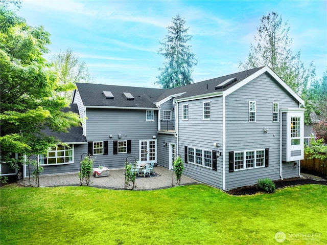 back of property featuring a patio and a lawn