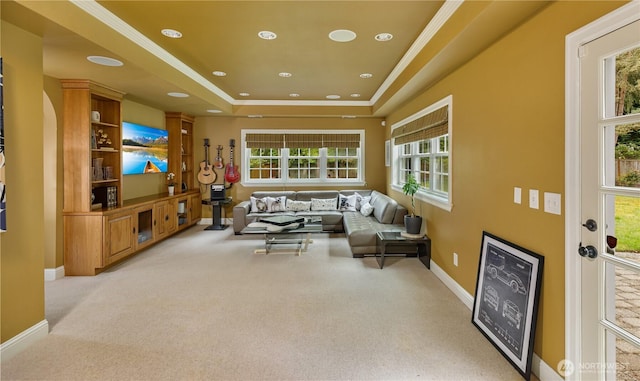living room featuring light colored carpet, baseboards, ornamental molding, a tray ceiling, and recessed lighting