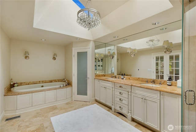 bathroom featuring double vanity, a sink, and a notable chandelier