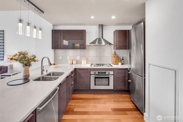 737 Olive Way Unit 3101, Seattle, WA 98101 - kitchen featuring stainless steel appliances, wall chimney range hood, a sink, light countertops, and recessed lighting
