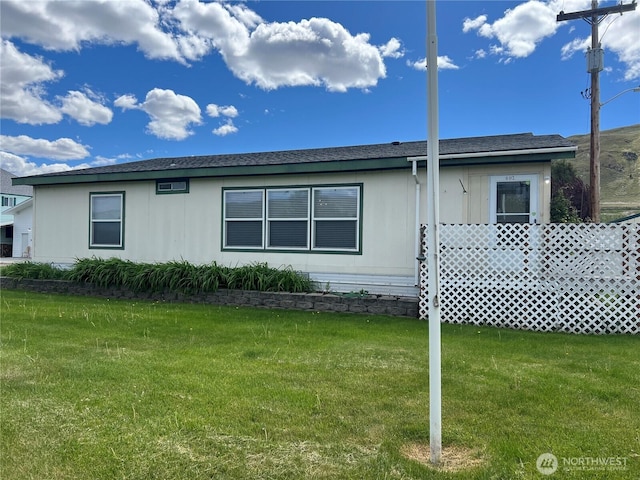 view of side of property with a lawn
