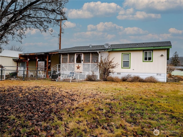 view of front of house with fence, crawl space, a sunroom, and a front yard