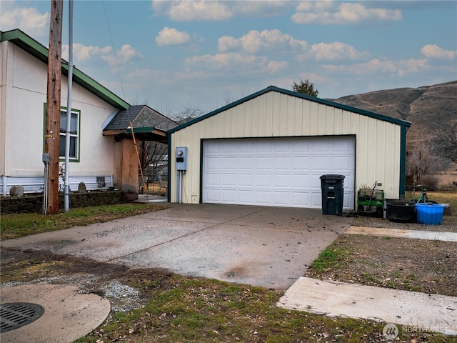 view of front of property with an outbuilding, a mountain view, and a detached garage