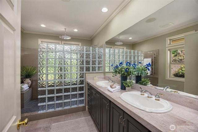 full bathroom featuring double vanity, a sink, walk in shower, and tile patterned floors