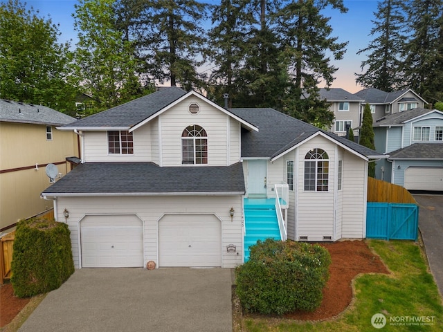view of front of property with a garage, fence, concrete driveway, and roof with shingles
