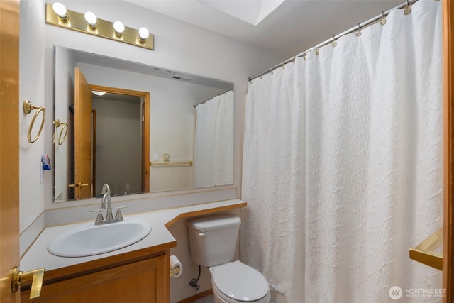 bathroom featuring vanity and toilet