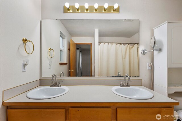 full bathroom featuring a sink and double vanity