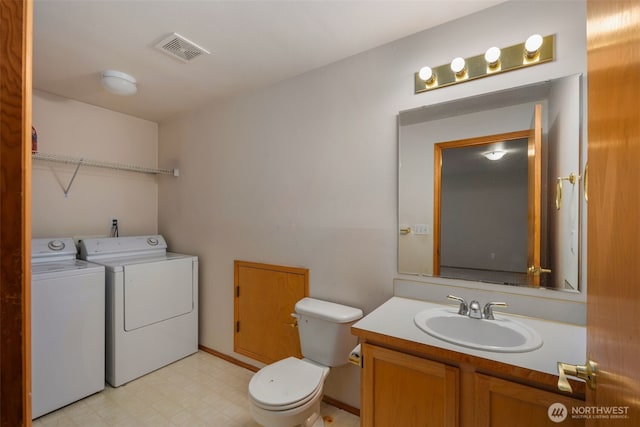 bathroom featuring visible vents, vanity, tile patterned floors, toilet, and separate washer and dryer