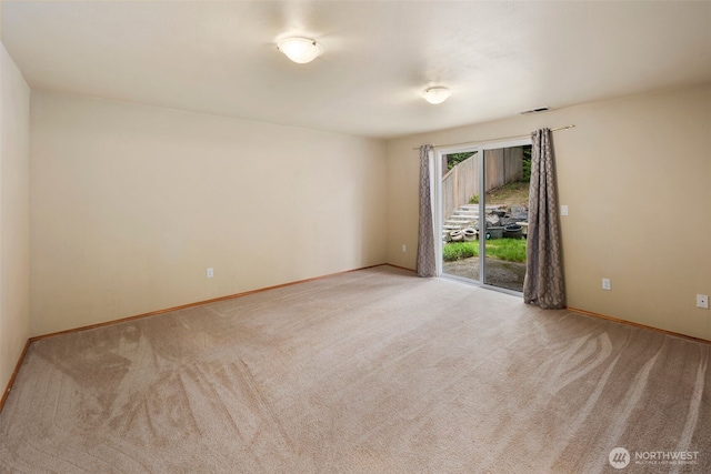 unfurnished room featuring baseboards, carpet flooring, and visible vents