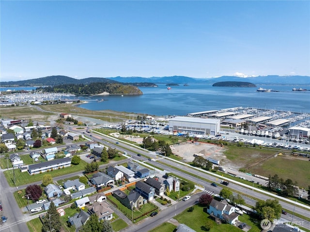 birds eye view of property featuring a water and mountain view