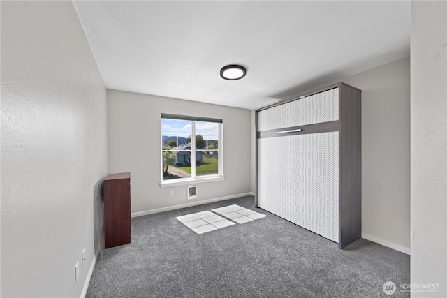 unfurnished bedroom with baseboards, visible vents, and carpet