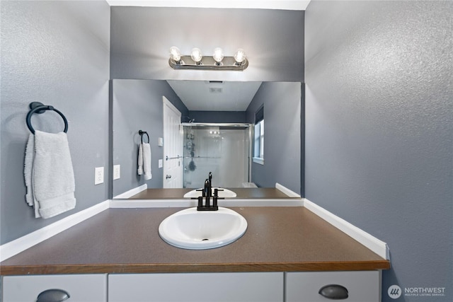 bathroom featuring vanity and a stall shower