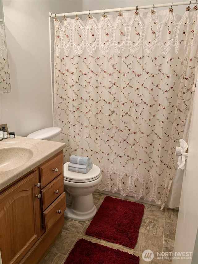 6110 24th Ave NW Unit 203, Seattle, WA 98107 - bathroom featuring toilet, vanity, and shower / tub combo