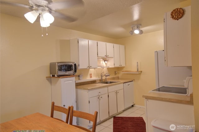 6110 24th Ave NW Unit 203, Seattle, WA 98107 - kitchen with white dishwasher, a sink, range, light tile patterned flooring, and a ceiling fan