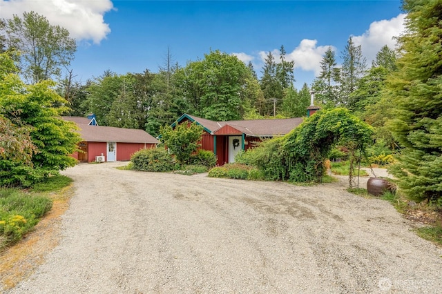 4027 S 275th Pl, Auburn, WA 98001 - view of property hidden behind natural elements featuring dirt driveway and a garage