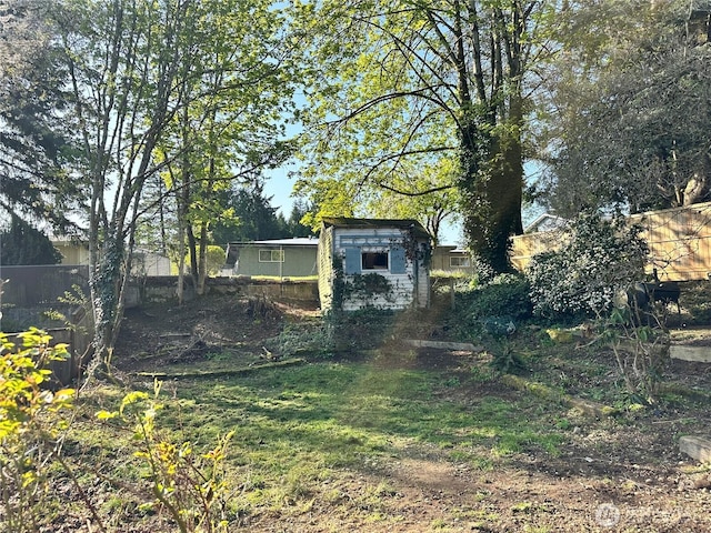 view of yard with an outdoor structure and fence