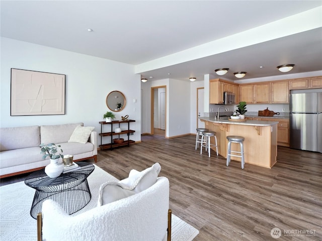 living area featuring baseboards and wood finished floors