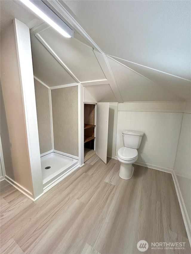 1145 Blaine St, Port Townsend, WA 98368 - full bathroom with lofted ceiling, wood finished floors, toilet, and a stall shower