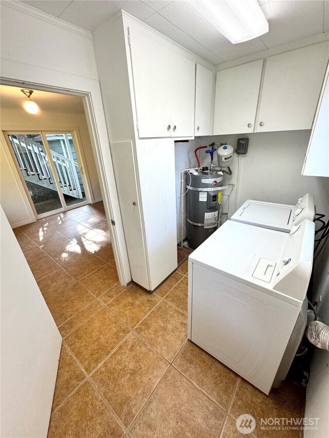 1145 Blaine St, Port Townsend, WA 98368 - clothes washing area featuring light tile patterned floors, independent washer and dryer, secured water heater, crown molding, and cabinet space