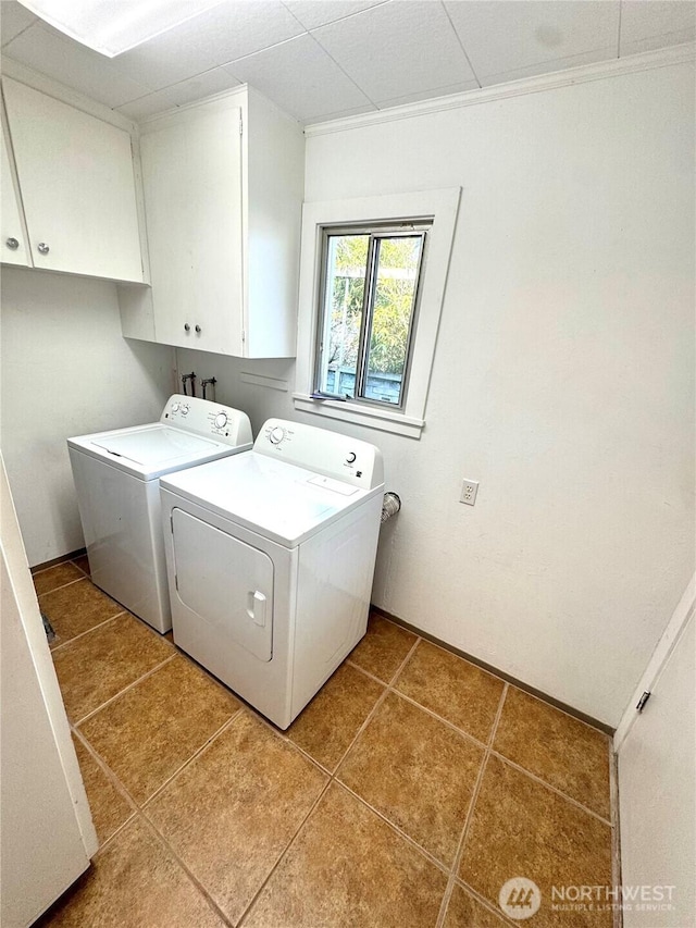 1145 Blaine St, Port Townsend, WA 98368 - clothes washing area with washing machine and dryer, cabinet space, and light tile patterned floors