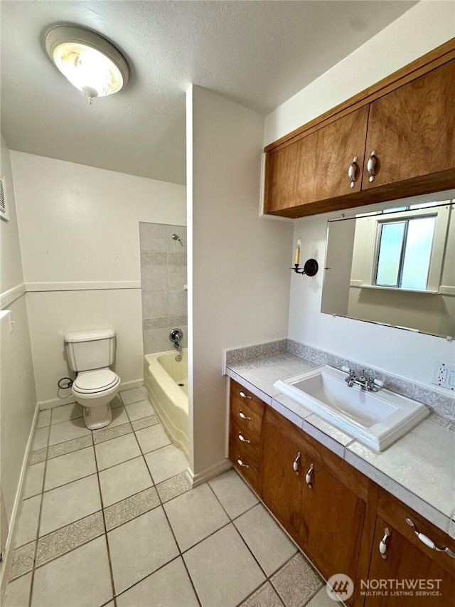 1145 Blaine St, Port Townsend, WA 98368 - full bath with a textured ceiling, toilet, baseboards, tile patterned flooring, and vanity