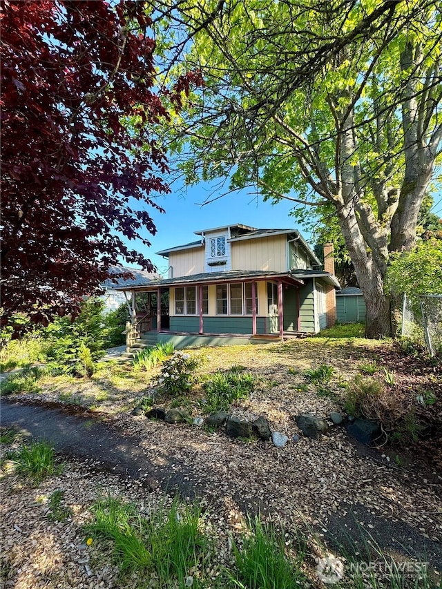 1145 Blaine St, Port Townsend, WA 98368 - view of front of house with a chimney and covered porch