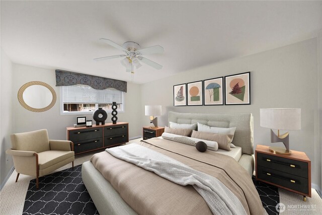 carpeted bedroom featuring baseboards and ceiling fan