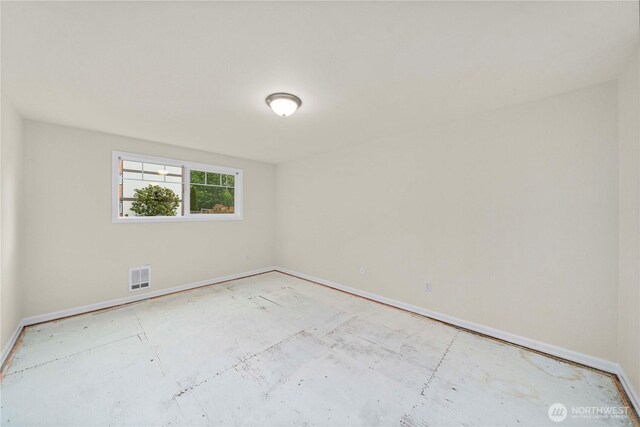 empty room featuring baseboards and visible vents