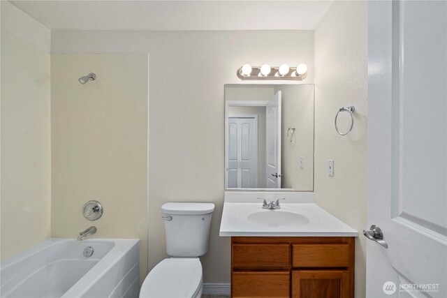 bathroom featuring toilet, shower / bathing tub combination, and vanity