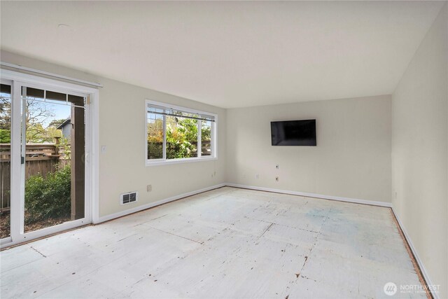 unfurnished room with baseboards and visible vents