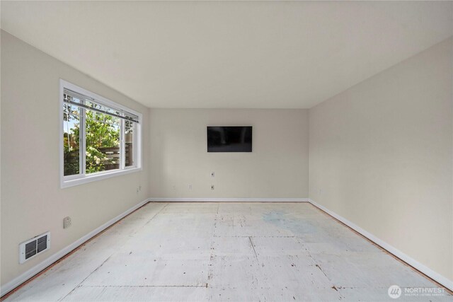 spare room featuring baseboards and visible vents