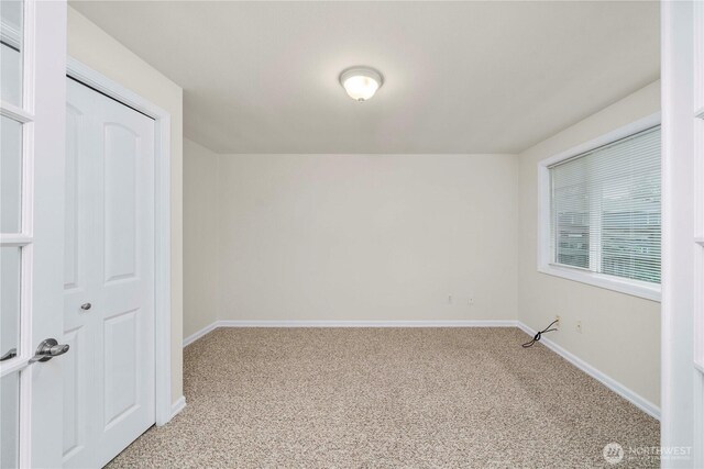 unfurnished bedroom featuring light colored carpet and baseboards