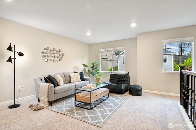 carpeted living area with recessed lighting, baseboards, and a healthy amount of sunlight