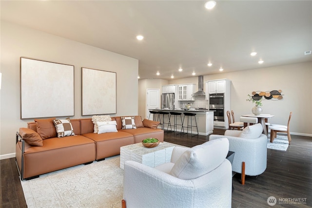 living room featuring baseboards, dark wood-style flooring, and recessed lighting
