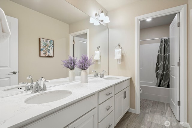 bathroom with a sink, shower / bath combo, and double vanity