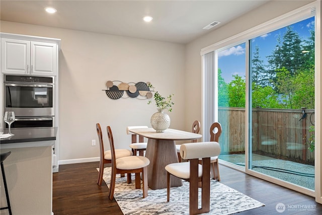 dining space with recessed lighting, baseboards, dark wood finished floors, and visible vents