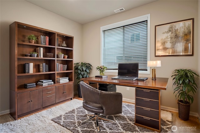 home office with baseboards and visible vents