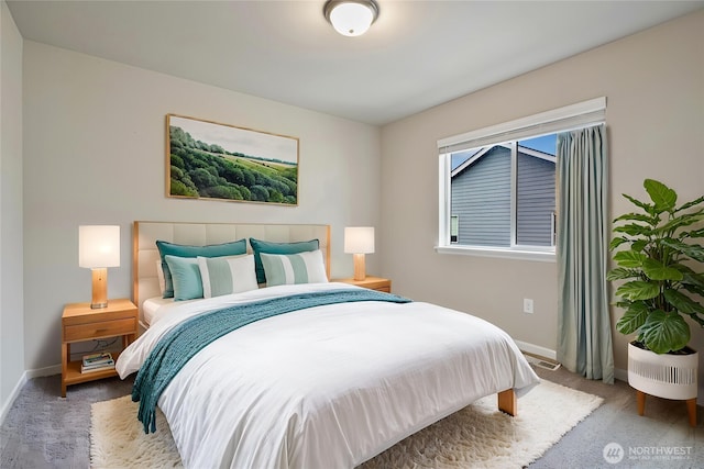 bedroom featuring baseboards and carpet flooring