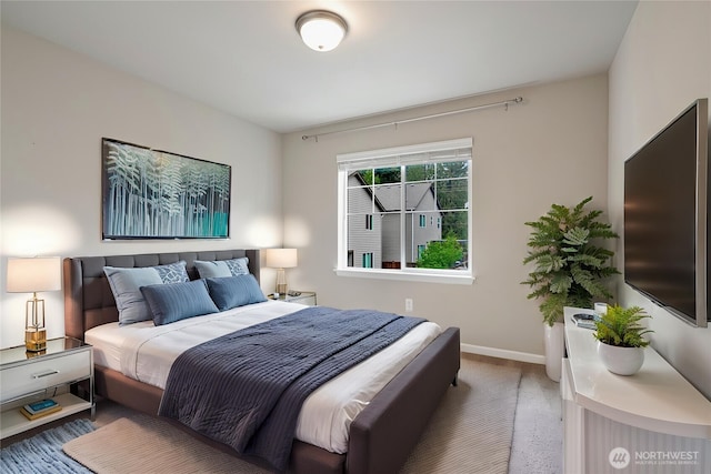 bedroom featuring baseboards and carpet