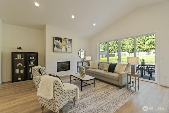 16106 Broadway Ave, Snohomish, WA 98296 - living room featuring wood finished floors, vaulted ceiling, a fireplace, baseboards, and recessed lighting