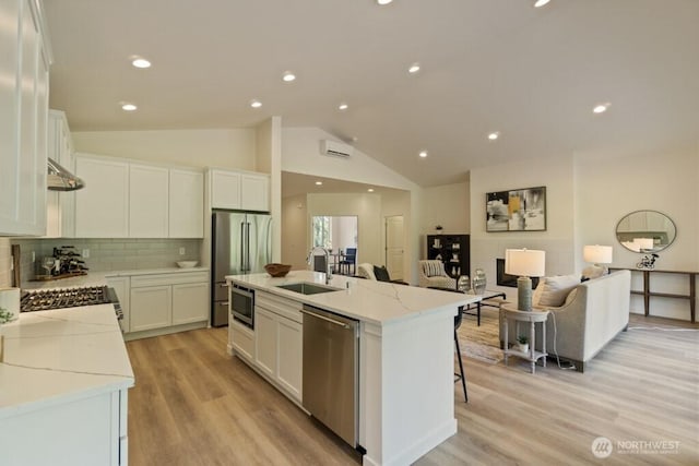 16106 Broadway Ave, Snohomish, WA 98296 - kitchen with appliances with stainless steel finishes, a sink, white cabinetry, open floor plan, and a kitchen island with sink