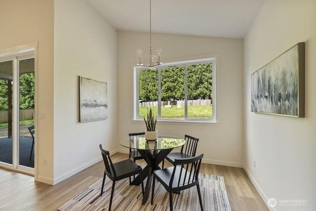 16106 Broadway Ave, Snohomish, WA 98296 - dining room featuring vaulted ceiling, wood finished floors, plenty of natural light, a chandelier, and baseboards
