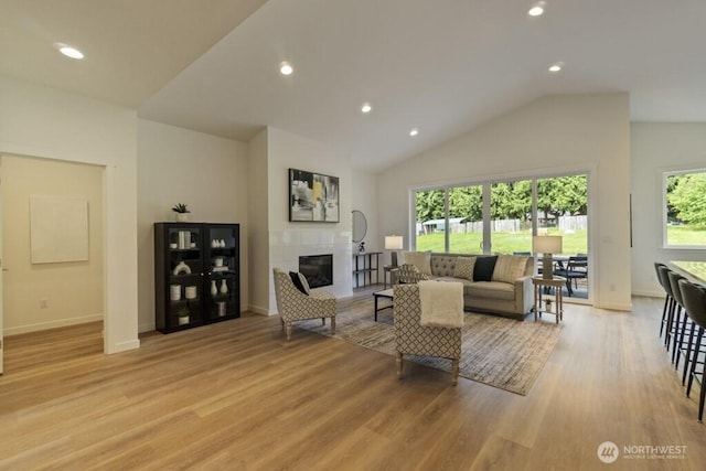 16106 Broadway Ave, Snohomish, WA 98296 - living area with light wood-type flooring, recessed lighting, a fireplace, baseboards, and lofted ceiling